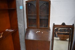 An Edwardian oak bureau and glazed book shelf with leaded light windows