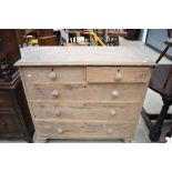 A Victorian stripped chest of two over three drawers