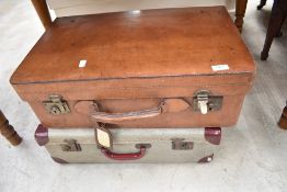 Two vintage travel trunks, one being leather