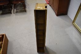 A commercial narrow metal rack having folding shelves
