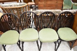 A set of four traditional wheelback dining chairs