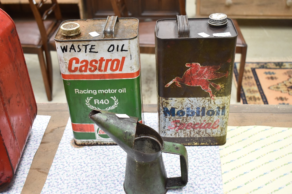 A vintage oil can and two oil tins