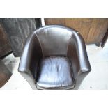 A modern brown vinyl tub chair