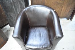 A modern brown vinyl tub chair