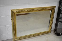 A modern gilt frame wall mirror