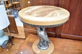 A modern occasional table having eagle column