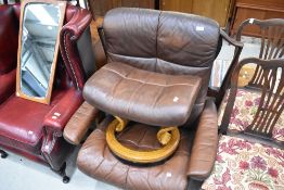 A brown leather Stressless easy chair and footstool