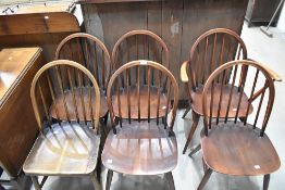 Six (five plus one) Ercol dark stained kitchen dining chairs having hoop and stick back