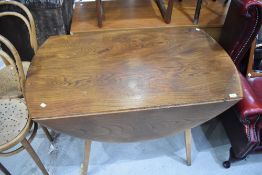 An Ercol mid stain drop leaf table