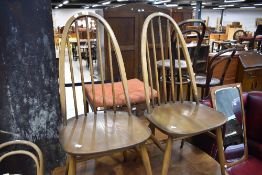 A pair of Ercol high hoop and stick back dining chairs