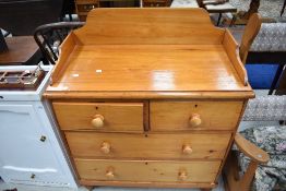 A Victorian stained pine wash chest of two over two drawers