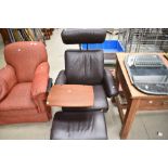 A modern brown leather Stressless armchair with footstool