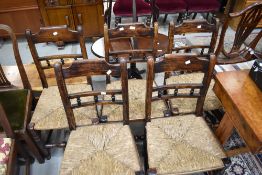 A set of five 19th Century stained frame kitchen chairs having rush seats and bobbin backs
