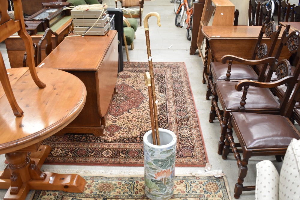 An oriental ceramic stick stand and two horn handled crooks