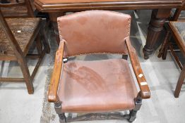 A traditional oak low seat armchair