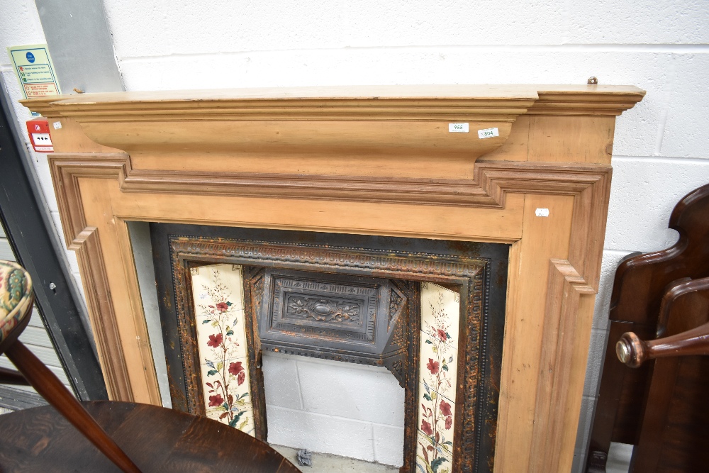 A Victorian style cast , tiled and stripped wood fire surround