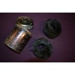 An unusual lot, consisting of an antique tin containing a pair of black fur childrens cuffs or