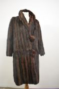 A vintage fur coat having large self covered buttons and Millers of Dundee label.