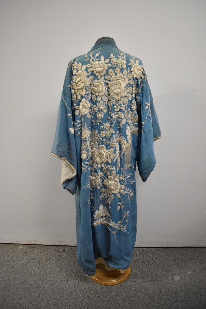 An early 20th century embroidered silk kimono dressing gown, damage to silk part of lining,