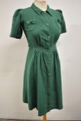 A green linen 1940s day dress having remnants of a CC41 utility label to neck, AF.