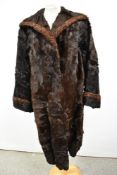 A vintage full length 1940s fur coat having contrasting edges to cuffs and collar.