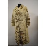 A vintage 1960s full length cream and brown fur coat.