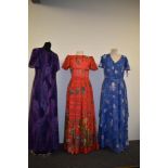 Three bright 1960s to 1970s maxi dresses.