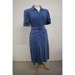 A blue wool 1940s day dress having belt to waist, metal zip to centre front, and vented skirt,