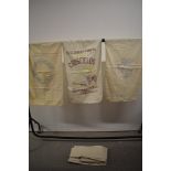 A selection of vintage feed sacks, some with lovely local advertisments on, others plain.
