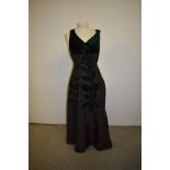 A 1950s Michael Paul model evening gown in black taffeta with green velvet appliqué pattern and