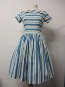 A 1950s blue striped cotton day dress having features buttons to collar, back metal zip, full