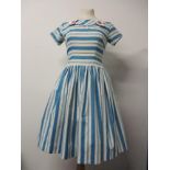 A 1950s blue striped cotton day dress having features buttons to collar, back metal zip, full