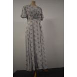 A 1930s floral day dress having press stud fastening to side, V neckline with smocking to