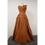 A 1950s copper coloured taffeta evening gown with button detail to skirt, AF.