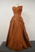 A 1950s copper coloured taffeta evening gown with button detail to skirt, AF.