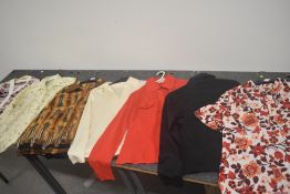 Seven vintage ladies tops and blouses in vibrant patterns, various sizes and styles.