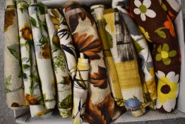 A box full of vibrant vintage 1950s and 1960s fabrics, including stunning rose patterned bark