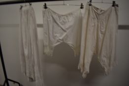 Two Victorian petticoats having lace work and pin tucks to hems, a pair of knickers having