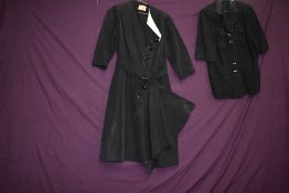 An unusual late 40s/50s black dress with asymmetric statement buttons, contrasting white accents and
