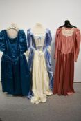 Three 1970s to 1980s gowns, including blue and white satin dress with train.