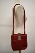 A red leather Gucci handbag, soft and supple leather with metal toggle to strap bearing the Gucci