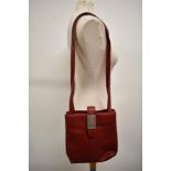 A red leather Gucci handbag, soft and supple leather with metal toggle to strap bearing the Gucci