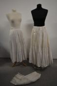 Two antique petticoats and a pair of bloomers.