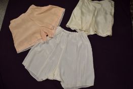 Three pairs of vintage tap pants, including 1930s pink pair with embroidery to legs