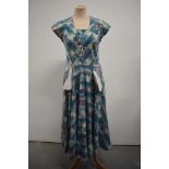 A Vintage 1950s day dress of floral cotton, having pockets to front and side metal zip.