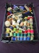 An assortment of vintage buttons, fastenings and threads.