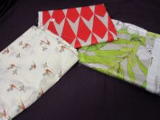 Three large pieces of fabric, including pheasant patterned length and two length of Romo fabric, one