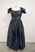 A 1950s Murray Arbied, London labelled off the shoulder evening gown in metallic blue having bow
