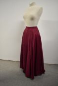 A 1950s wine coloured taffeta full circle evening skirt having side metal zip.