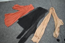 Three pairs of vintage stockings including red knitted pair and black seamed pair.